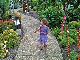 Little girl walking through a garden