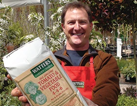 Man in garden holding plant food