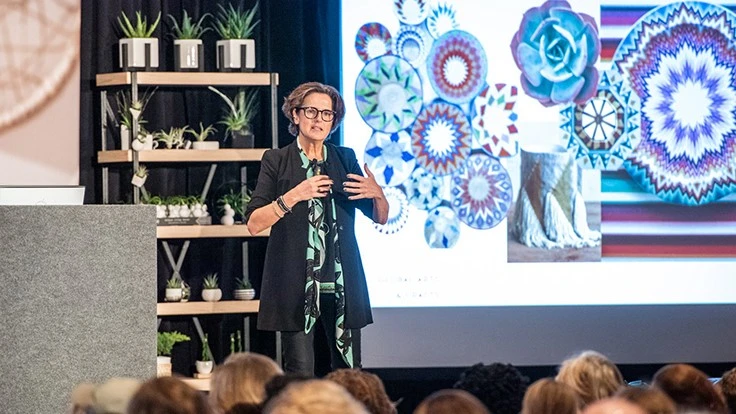 Woman speaking at a conference on a stage