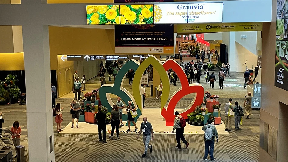A large convention hall with people milling about.