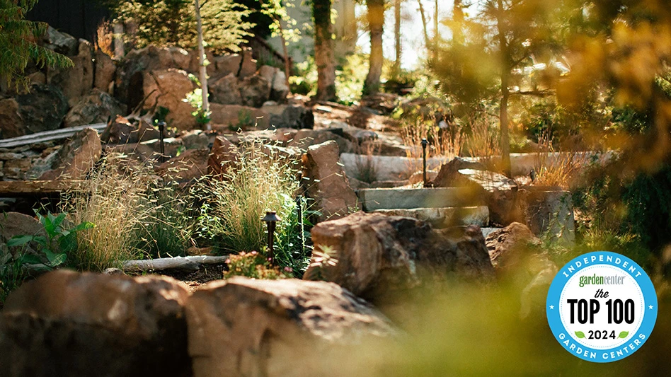 A view of rocky landscaping at Colonial Gardens in Missouri with autumn leaves in the foreground