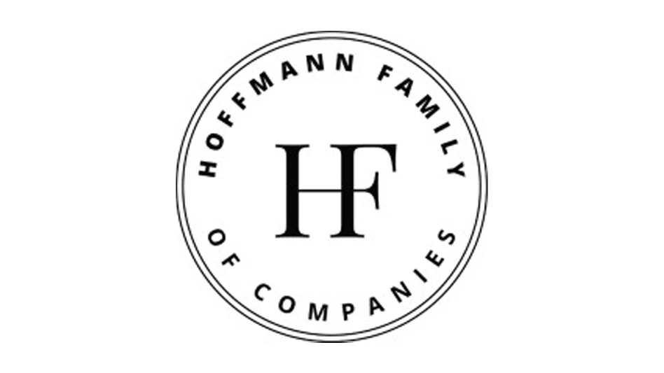 A logo with black text in a black circle on a white background reading Hoffmann Family of Companies, with a large HF in the middle of the circle.