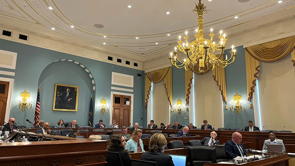 A House Committee on Agriculture meeting in Washington, D.C., in a high-ceilinged room with blue walls and a gold chandelier.
